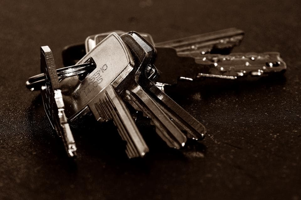 A bunch of old keys on a dark table